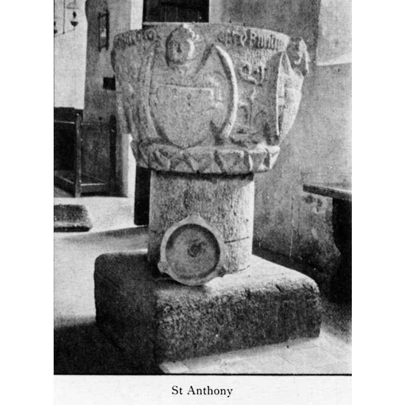 the object propped against the stem may be a holy-water stoup, but it appears to have a drain hole, which would be unsual in a stoup