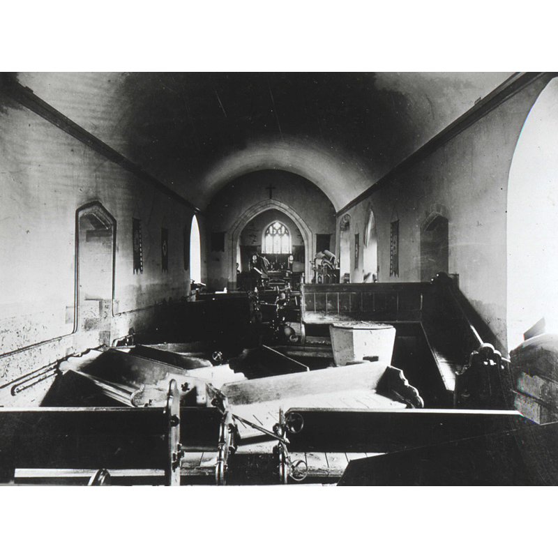 "Interior of Dixton Church after the flood in 1910"; the font is visible in the foreground, behind some benches