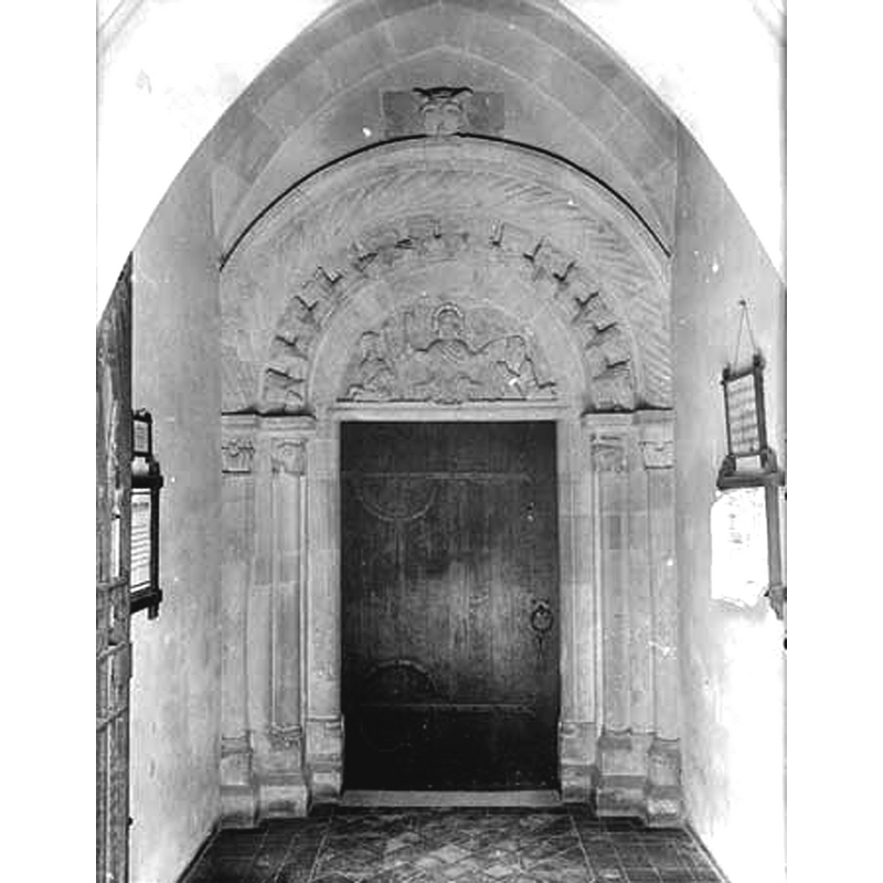 Source caption: "The Norman south doorway to the church, decorated with beak-head and cable mouldings. The tympanum shows Christ in Majesty and two figures said to be St Peter and the donor."