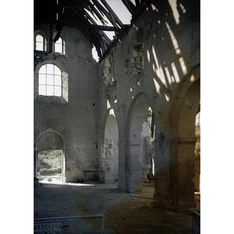 the modern font is visible at the far end, on the right side of the arcade -- the photograph, taken in 1917, shows the state of the church in WWI
