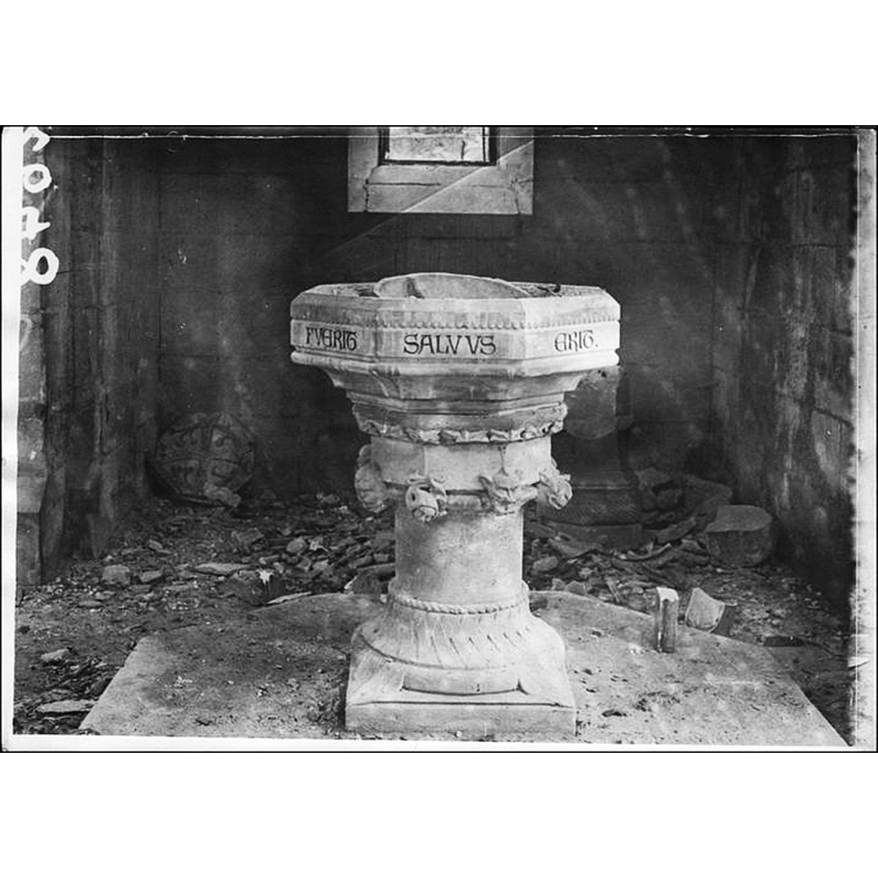 modern font inside the church during WWI; the object in the back, left-hand corner, appears to be the wooden font cover