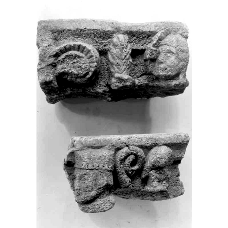 these two fragments were believed to have been part of the medieval font of Selånger old parish church; these two were not used in the final reconstruction -- the top fragment has a partial view of Christ nimbed head, a hand (?) holding a palm (?), and a radiated shape on the left -- the bottom fragment has the head of a mitred bishop with his baculum behind