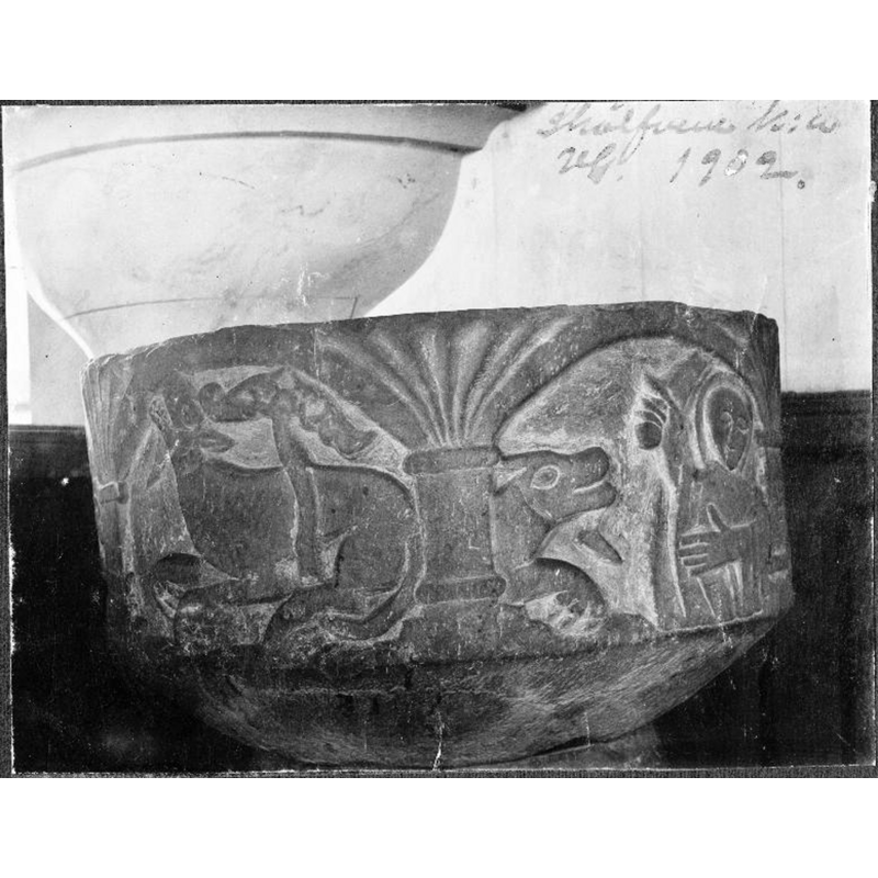 Source caption: "Dopfunt av sandsten, medeltida. Cuppan visar en framställning av S:t Görans kamp mot draken. Detalj av cuppan."