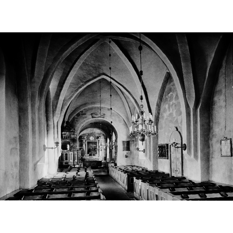the font, only partially visible, is located beneath the chancel arch, south side
