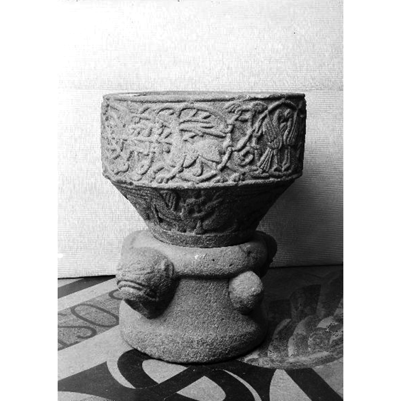 all around the basin sides; six have animals in them, one has a wheel-like motif