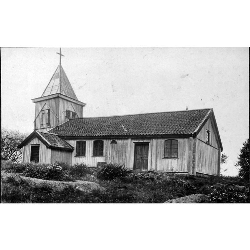 Source caption: "Kyrkan med torn på ursprungsplatsen." -- the wooden church of ca. 1604 (the tower was a later addition) seen here in its original location; it was moved to the open-air museum site in 1921