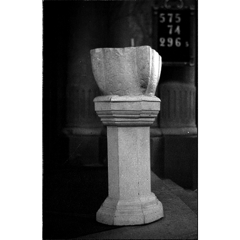 the old stoup(?) mounted on a wooden octagonal pedestal base and serving as baptismal font in this church