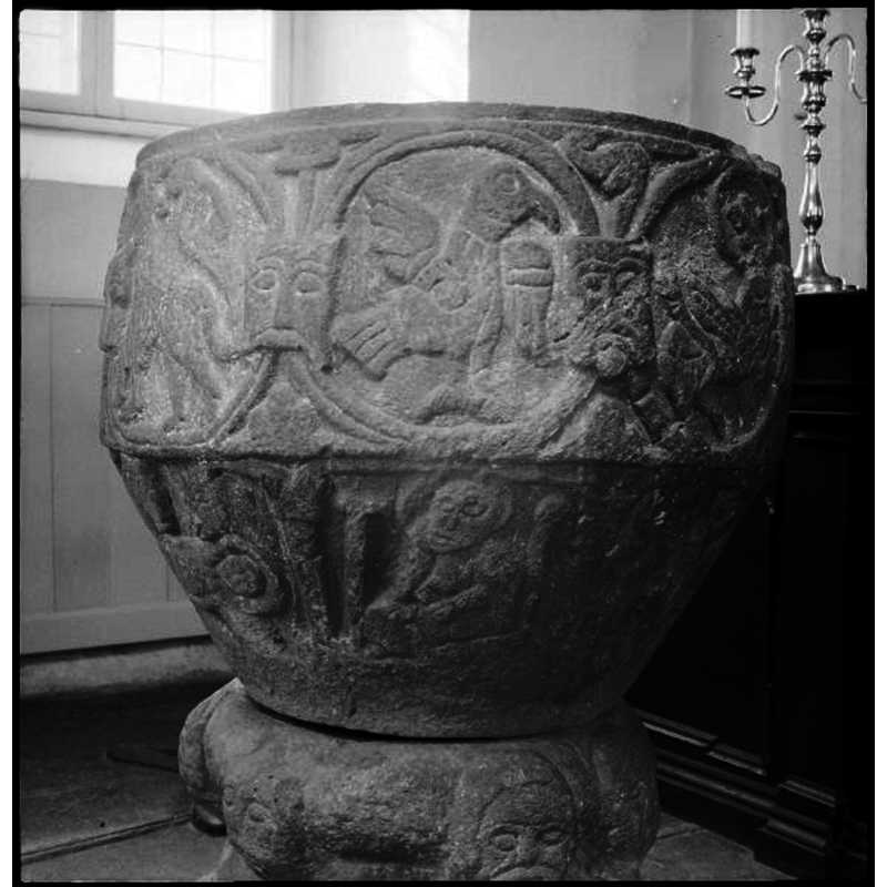 the bird and the winged lion may have been meant to be symbols for John and Mark respectively, together with a haloed angel holding a scroll on the uderbowl but, like many of the mostifs and symbols on this font, of questionable identification -- on the underbowl: Joseph dreams in the centre as part of the Nativity scene that covers the left side as well