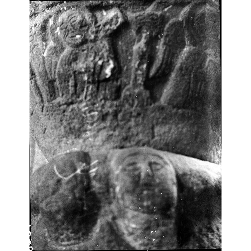 a human figure haloed on the left; on the right is a haloed angel holding a book