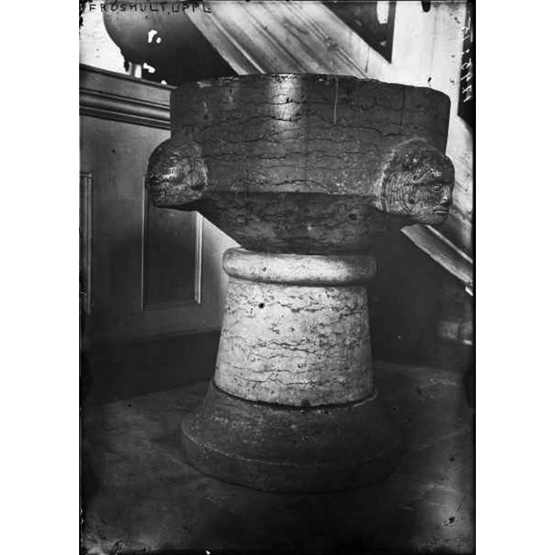 the font is located at the foot of the pulpit in this image