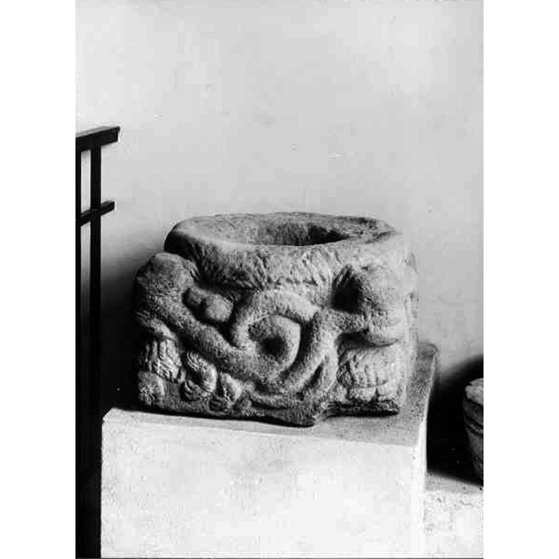 the base of the medieval font as displayed in the museum