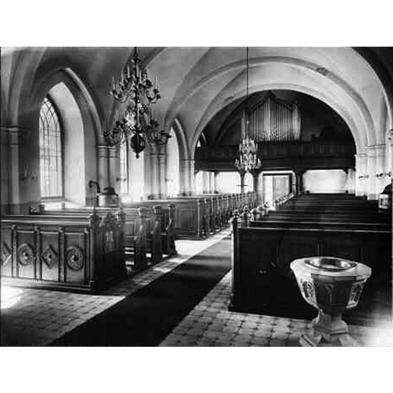 the baptismal font, probably of the same date as the new church, is seen here in the foreground, but the baptismal dish on the font is 16thC
