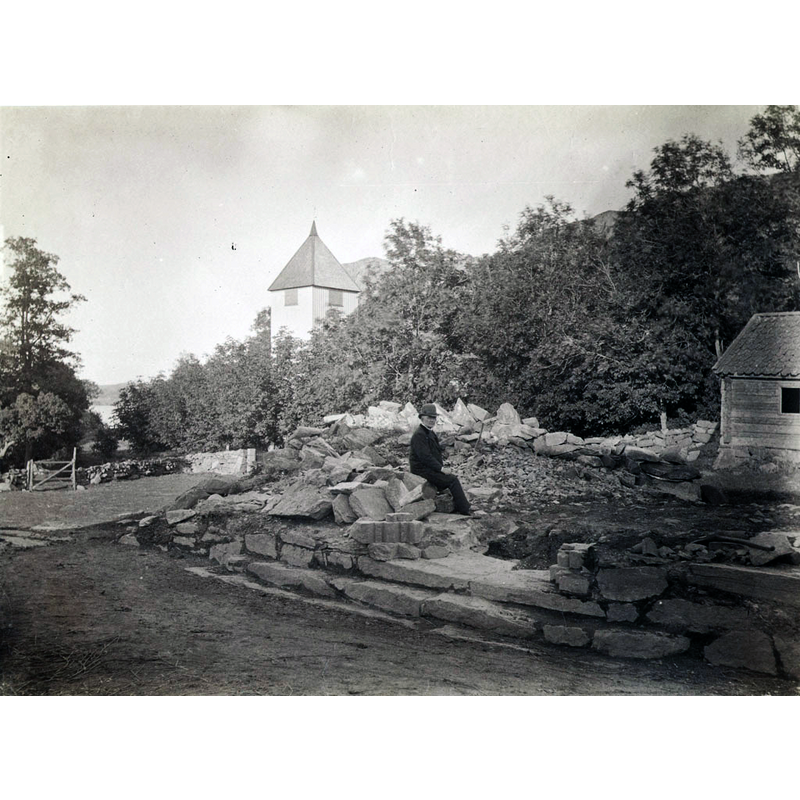 Source caption: "A man sitting outside Dragsmark Church on the Swedish West Coast."
