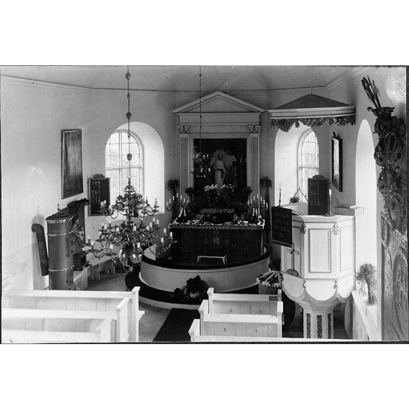 chiefly a view of the chancel -- the old font is partially visible between the pulpit and the communion railing, with a fancy cover on it