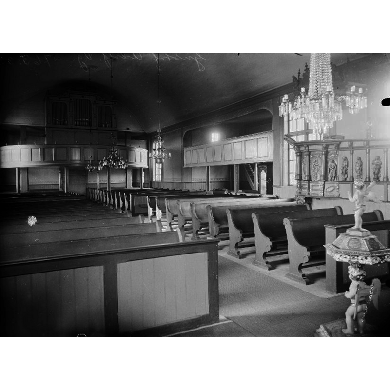 the photograph, taken before the 1925 restoration of the church, shows the later (1719) font in the foreground, right side