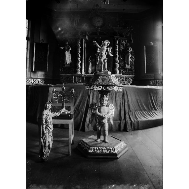 the wooden baptismal font of 1719 in the context of the pre-1925 restoration interior