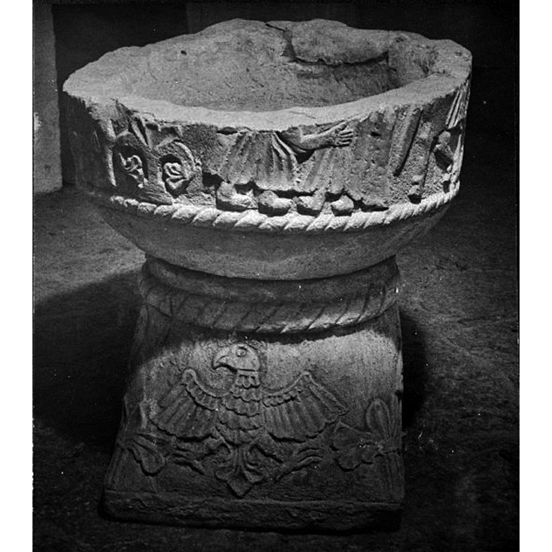 only the lower parts of the bodies are visible in the remaing fragment -- by the position of the feet it appears that two figures face each other, the arm of the one on the left reaching towards the other; at the extreme right the hind quarters of a quadruped