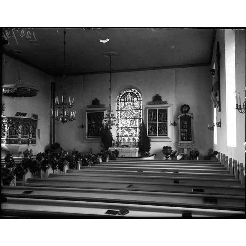the baptismal font is partially visible at the far end, between the altar and the psalm board