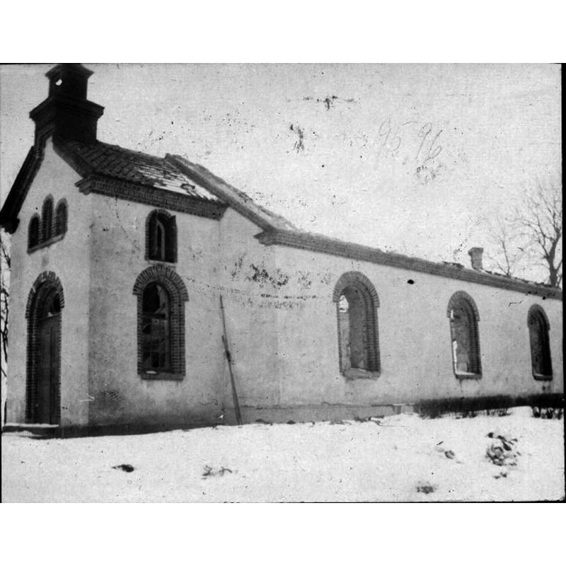 view of the church immediately after it was gutted by fire -- Source caption: "Kyrkan från sydväst efter branden 1919."