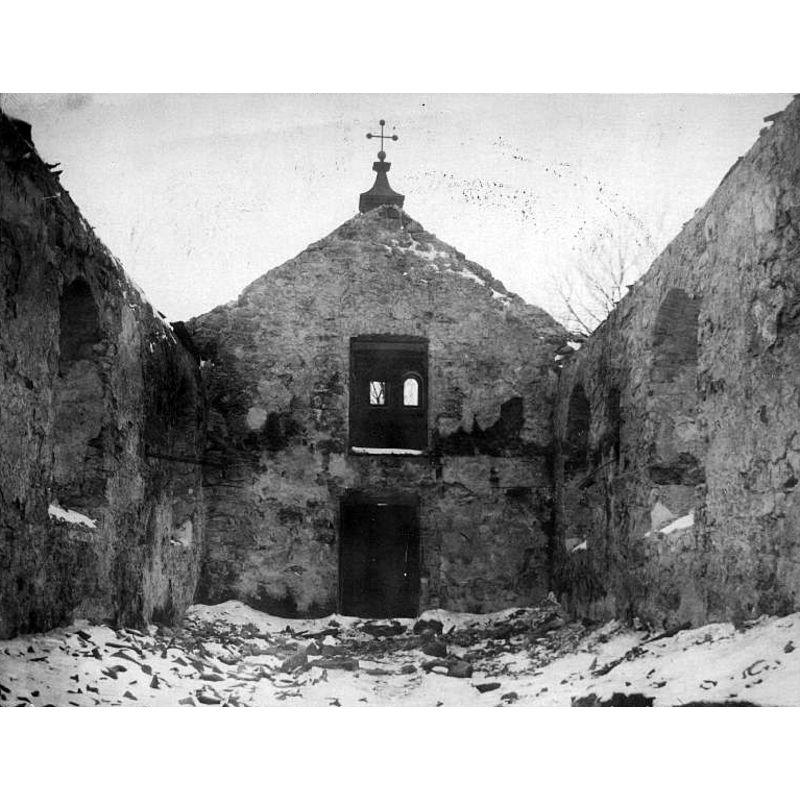 view of the church immediately after it was gutted by fire -- Source caption: "Interiör mot väster efter branden 1919."
