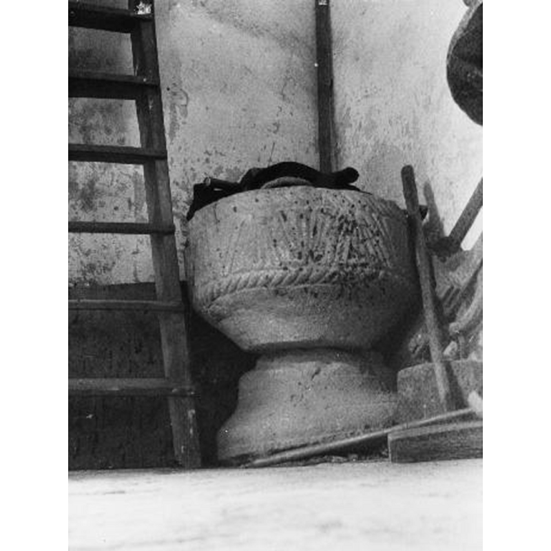 the medieval font at the time when it was not in use, after the introduction of the new wooden font ca. 1698