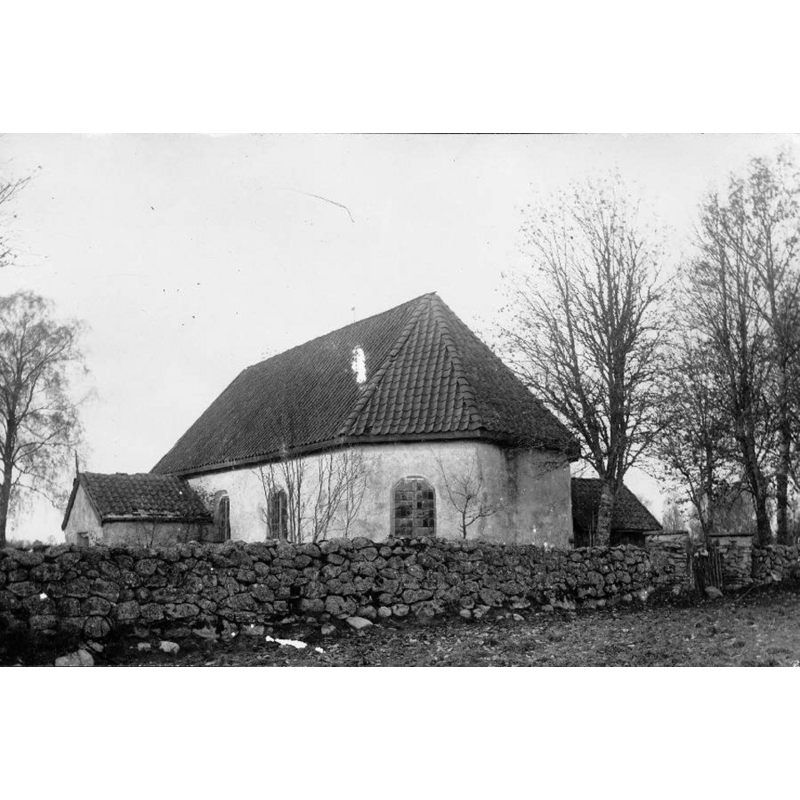the old church behind the churchyard stone fence