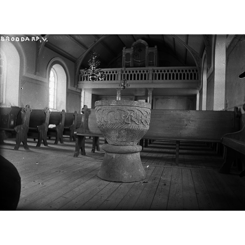 the medieval font in the northeast corner of the nave of the new church