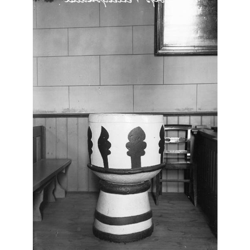 the painted medieval font about half-way down the north side of the nave; photograph taken before the 1938-1943 renovation, when the paint was removed