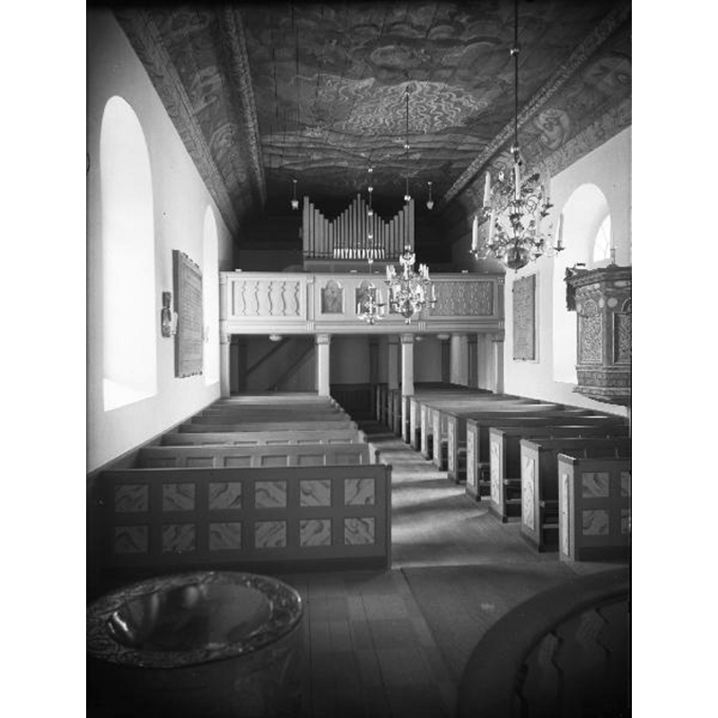 the medieval font seen here after the 1950 restoration of the church, at the east end, just right [south] of the communion railing -- Source caption: "Algutstorps kyrka [...] Interiör mot väster. Efter restaurering."