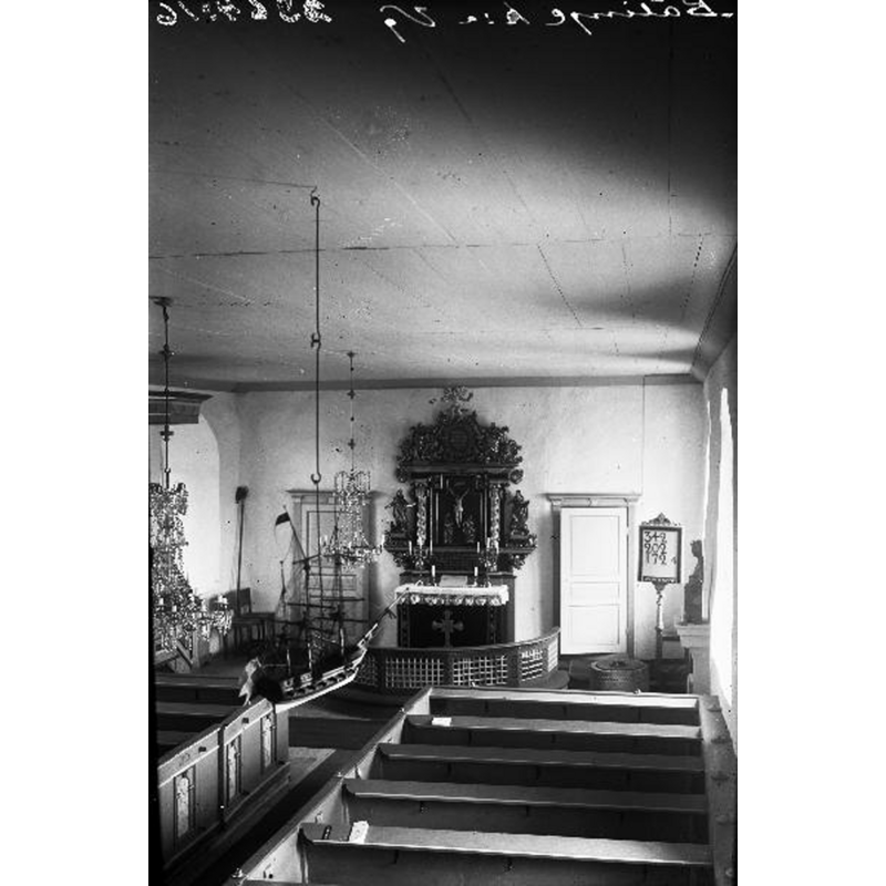 the top of the baptismal font is visible at the far [east] end, right [south] side