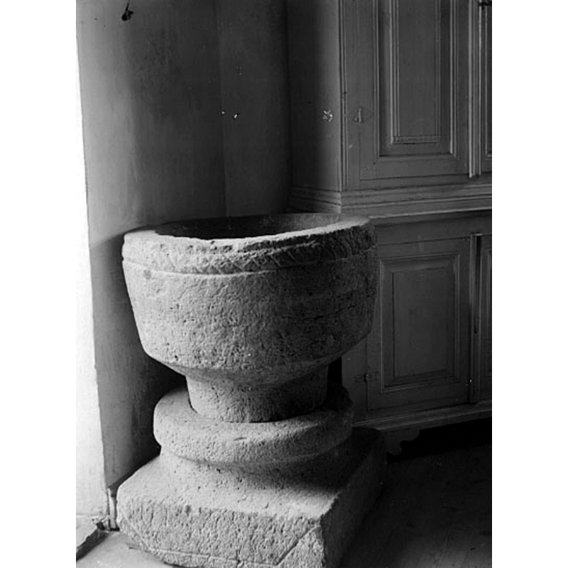 the medieval font photographed in 1919 inside the medieval church; a fire would destroy this church in 1929 but the font survived