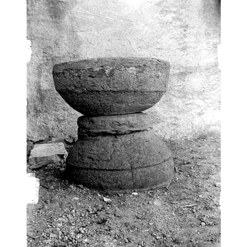 the pre-1954 photograph shows the font outside, probably in the churchyard, disused, eroded and damaged; the centre ring appears to be detached here but was probably part of the base block