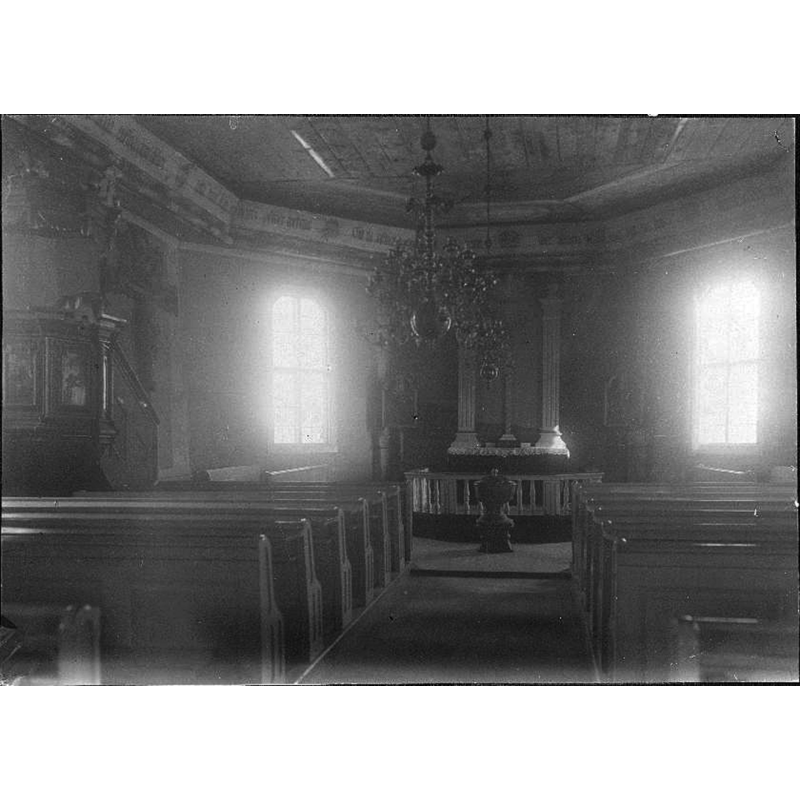 the photograph was taken before the 1929 renovation of the church interior; it shows the baptismal font standing in the centre of the chancel, just west of the communion railing