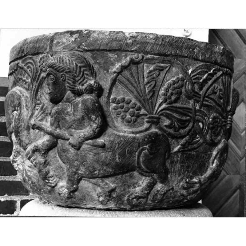 the centaur holds a weapon in its left hand and the leg of the fleeing lion in the right; notice the braided hair on the head of the centaur