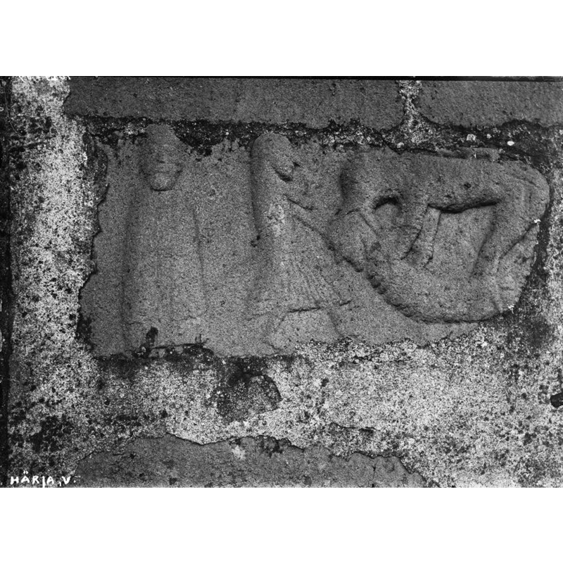 Source caption: "Härja kyrka [...] Exteriörer, detaljer [...] Stenskulptur, fragment, i östra gaveln" [NB: the figure on the left appears hieratic, perhaps a bishop? the warrior in the centre could have had a sword in his hand,now broken off; the scene on the right somewhat resembles the carving above the southeast portal]