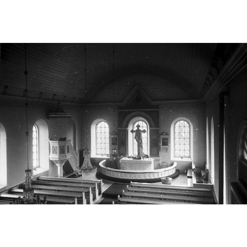 the medieval font is partially visible behind the pews on the far [east] end, right [south] side