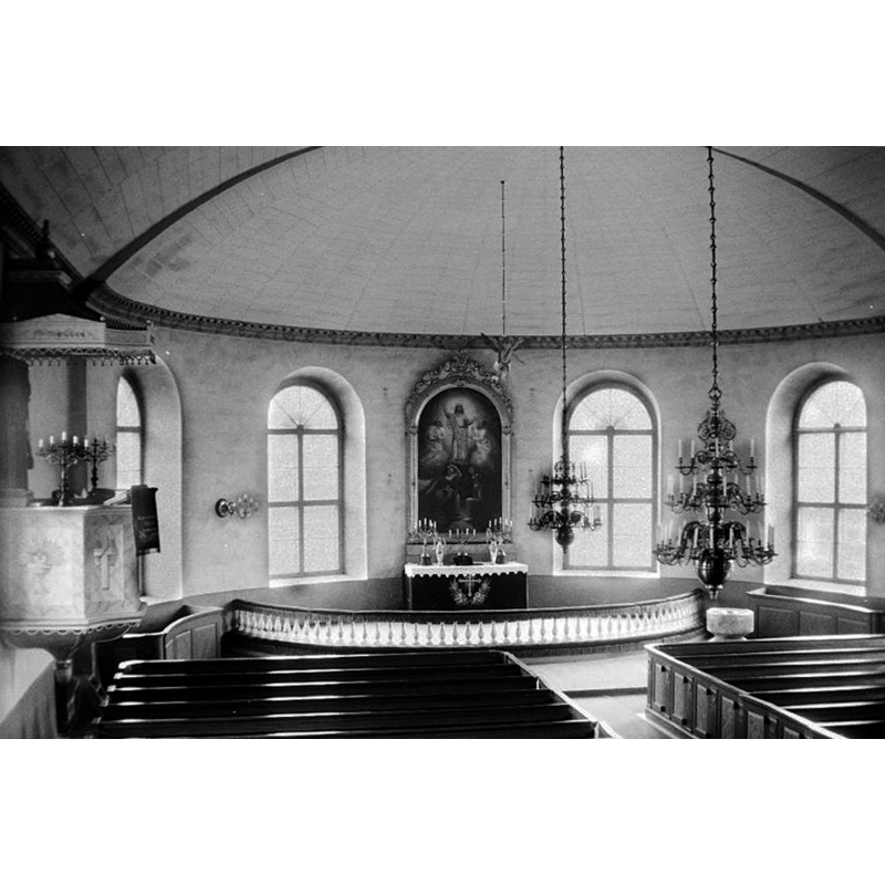 the medieval baptismal font is partly visible in the southeast corner