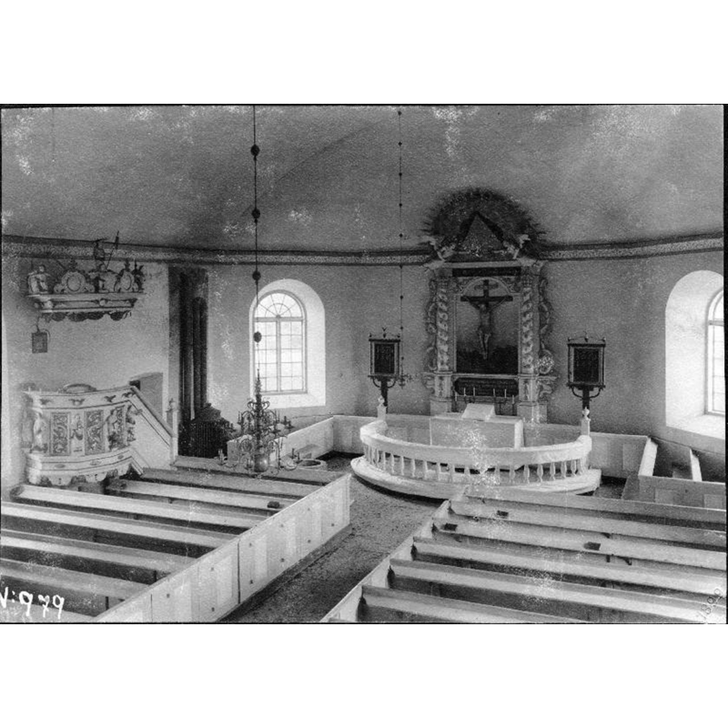 the medieval font is partially visible at the front end of the north bank of pews