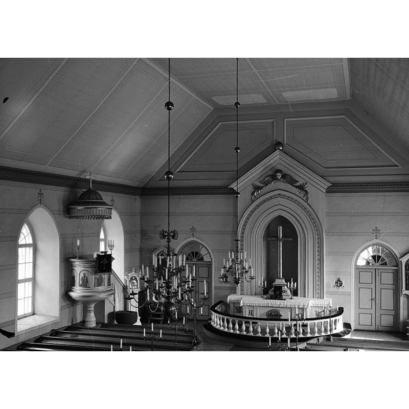 the medieval font is partially visible by the pulpit