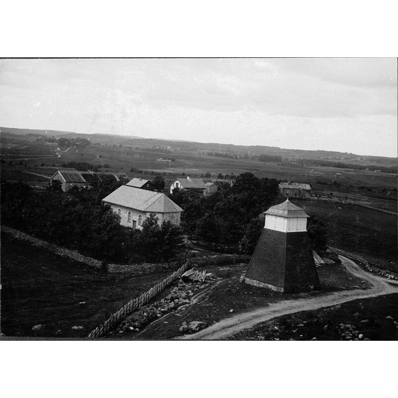 aerial photograph showing the detached old belfry east of the towerless church; a tower woukd be added in 1924