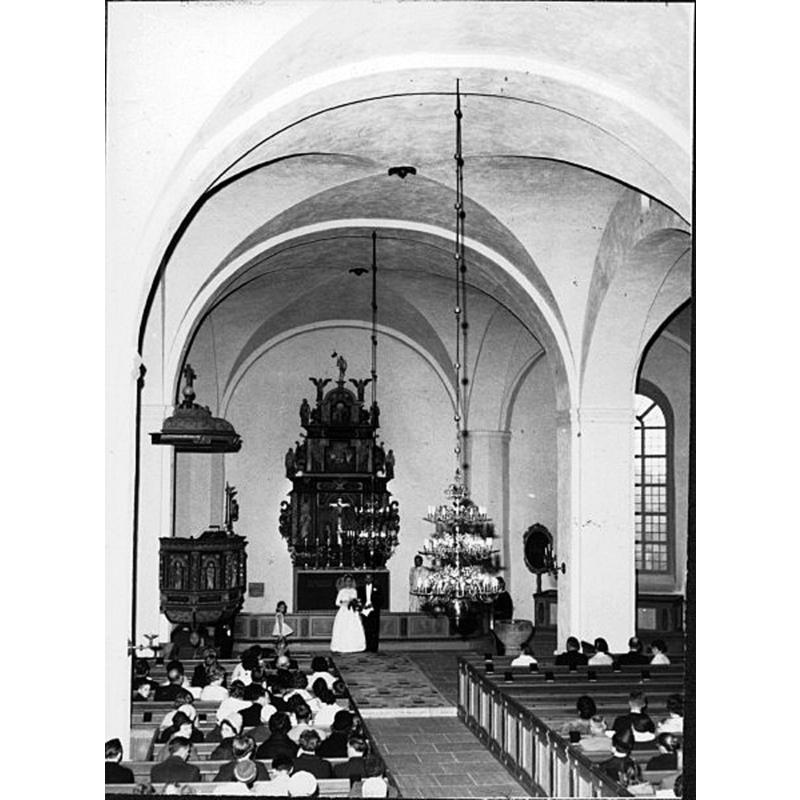 showing the medieval font by the right [south] pillar of the chancel arch