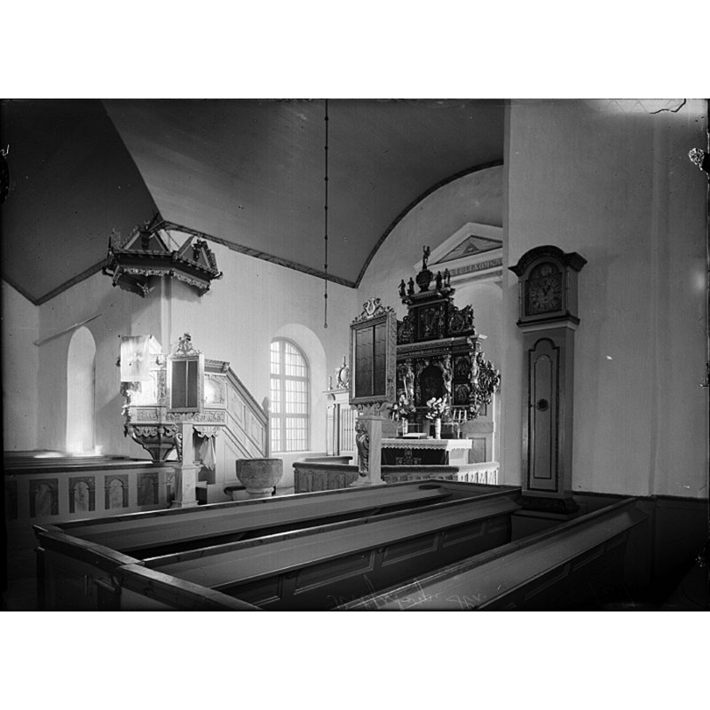 showing the medieval font at the east end of the centre aisle