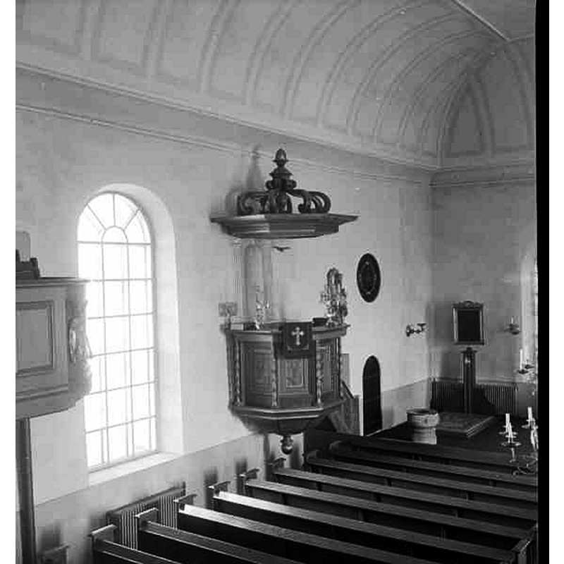 showing the medieval font near the sacristy entranceway