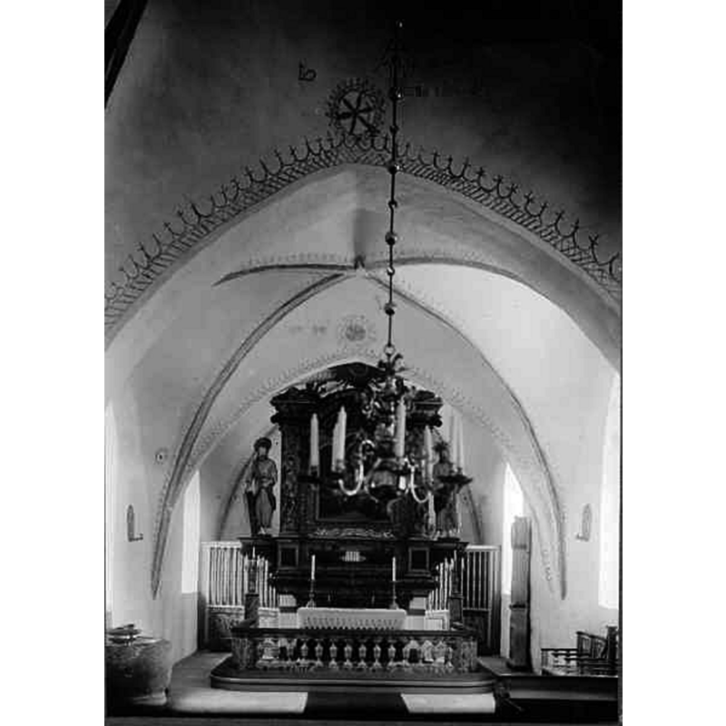 Source caption: "Barkåkra kyrka [...] Interiör mot öster." -- showing the medieval font on the bottom left [north] corner of the nave