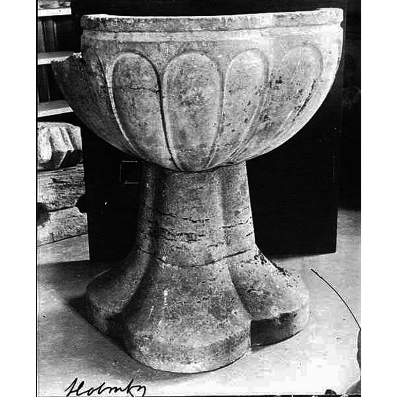 Source caption: Holmby kyrka [...] Äldre dopfunt." -- showing the medieval stone font in its damaged state