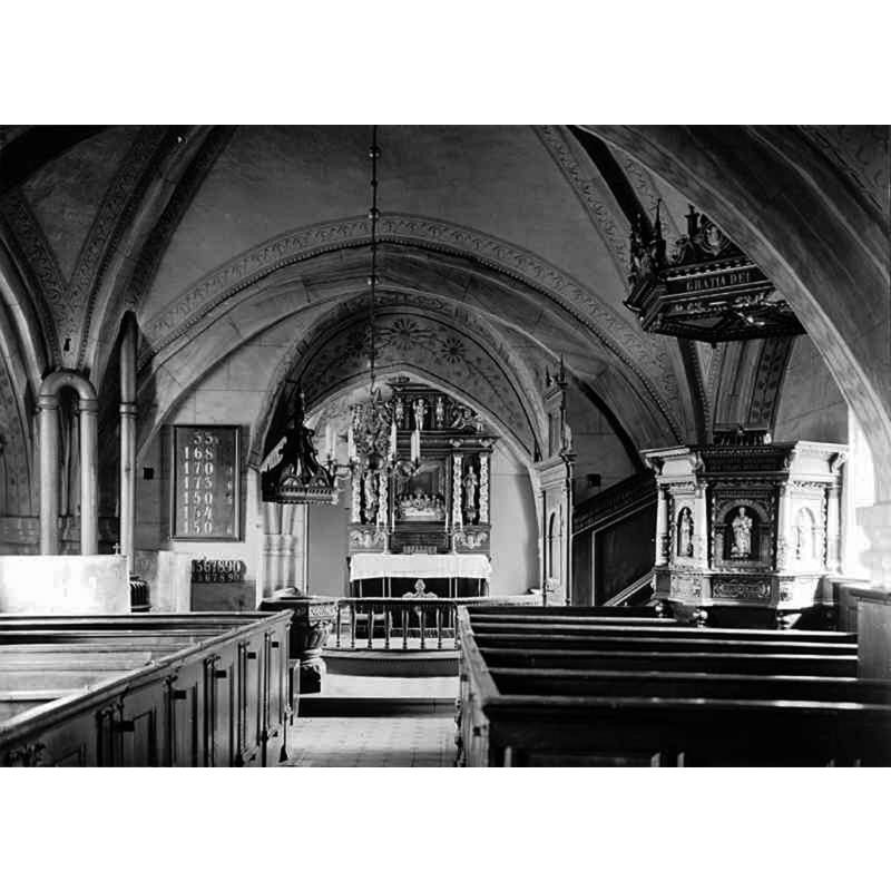 Source caption: "Nymö kyrka [...] Interiör mot öster." -- showing the baptismal font at the far [left] end of the left [north] bank of pews, and its canopy above
