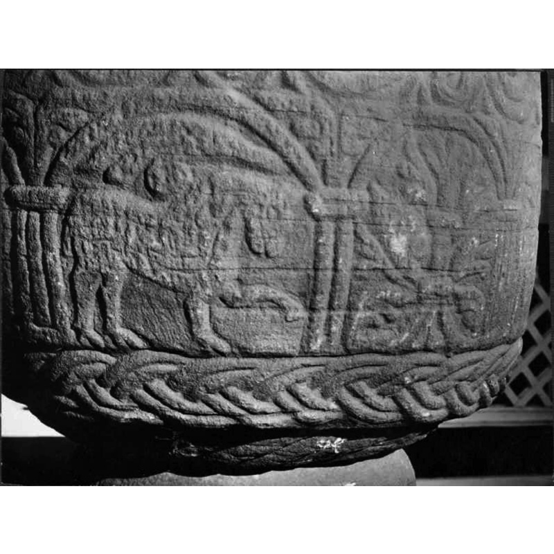 in the left arch here, passant to the right: it is the most 'feline' of the animals on this font; not clear whether the ornament on top is meant to be part of the animal