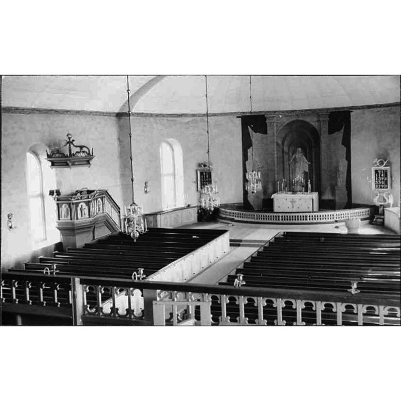 partially showing the medieval baptismal font in the southeast corner of the nave