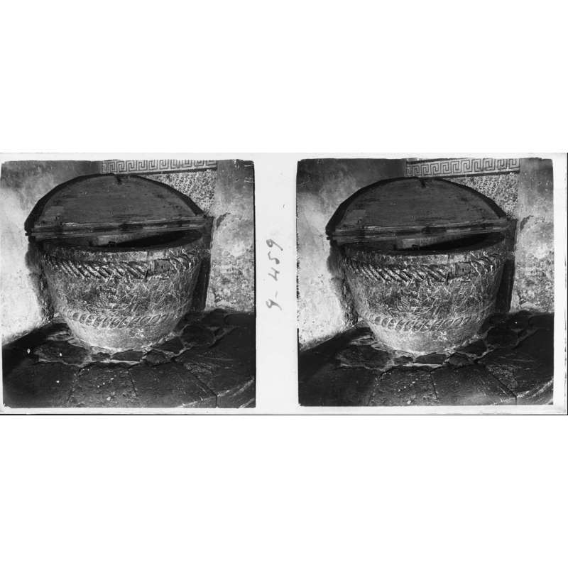 Source caption: "Pila baptismal de l'església romànica de Beget. Pila baptismal antiga del temple parroquial , declarat monument nacional , dedicat a sant Cristòfor , és un exemplar romànic molt notable (ss X-XIII) on és venerada la majestat de Beget ."