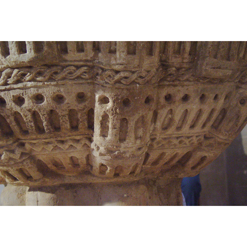 a continuation of the building ornamenting the upper side